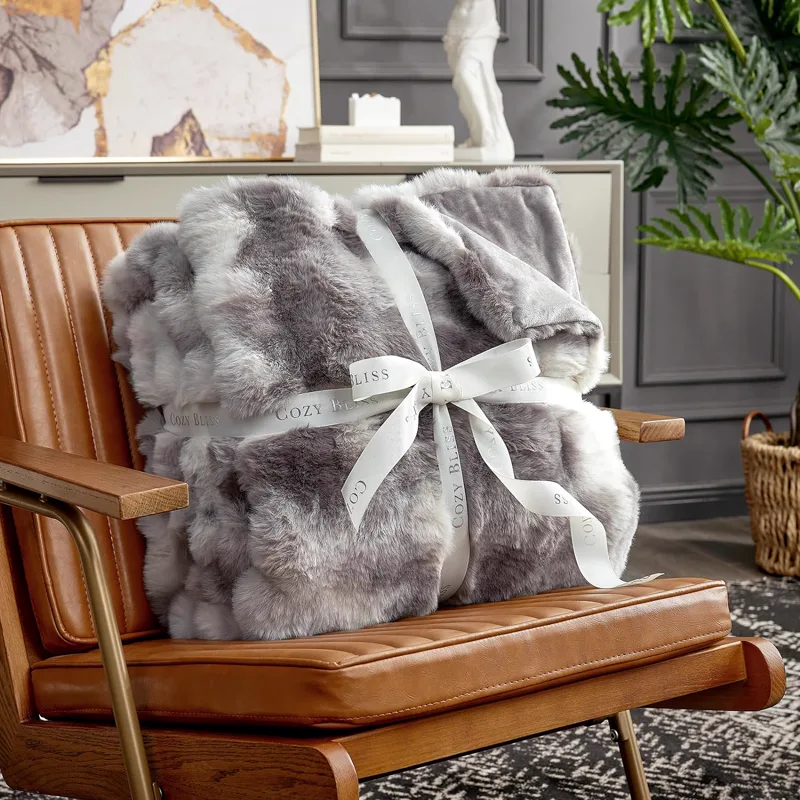 Gray and white faux rabbit fur blanket with gift ribbon