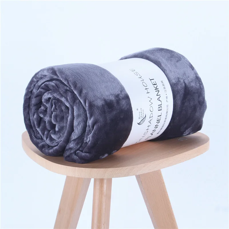 Charcoal solid flannel blanket rolled with paper band