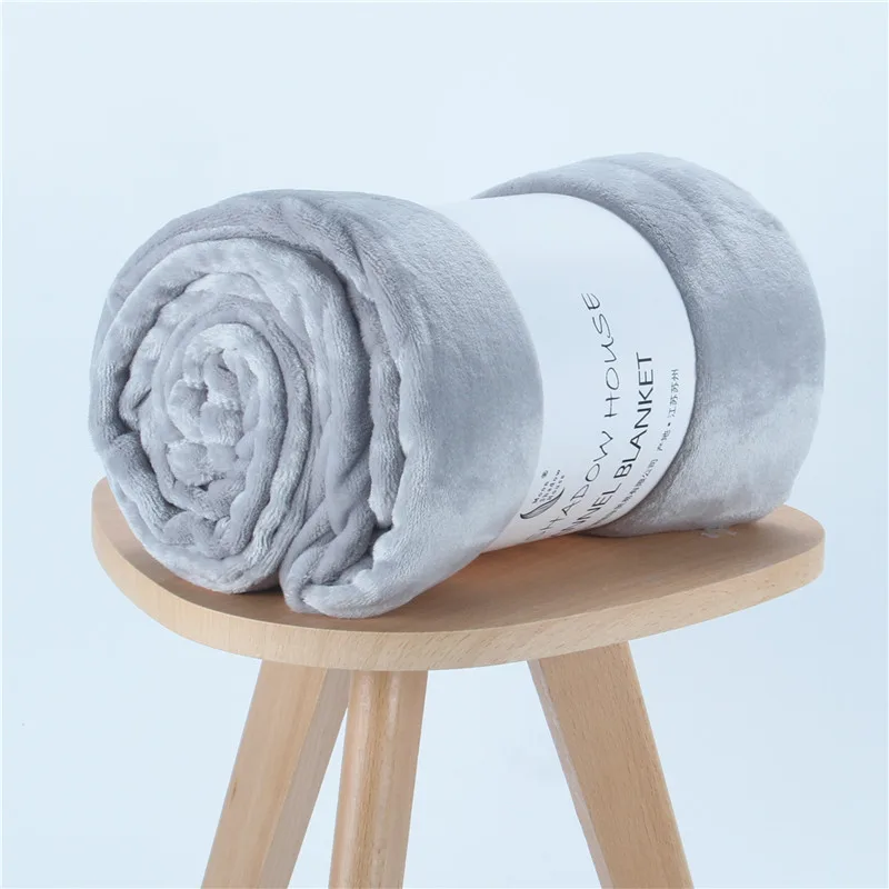 Gray solid flannel blanket rolled with paper band