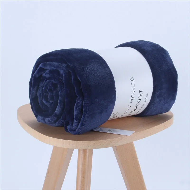 Navy blue solid flannel blanket rolled with paper band