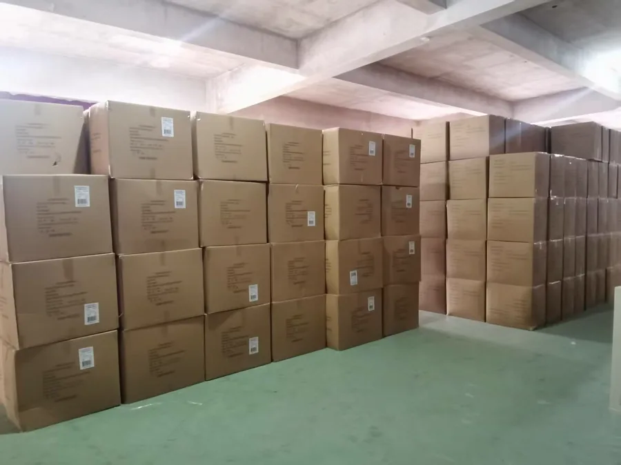 Finished goods warehouse with labeled export cartons stacked on racks