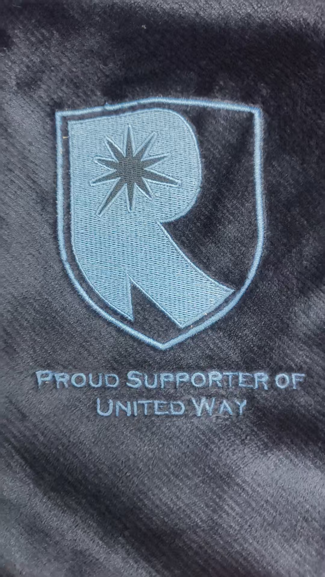Proud Supporter of United Way embroidered crest on navy blanket