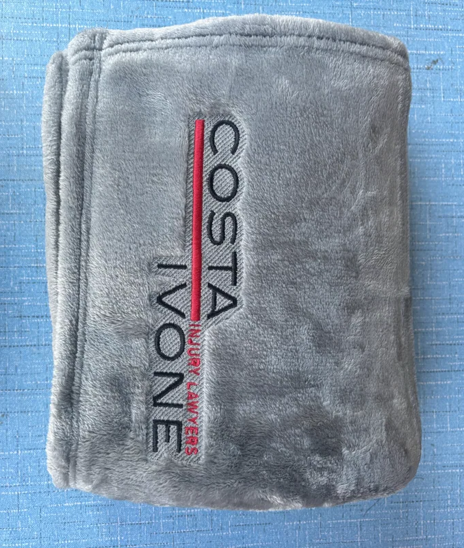 Costa Ivone Injury Lawyers embroidered logo with red accent on gray blanket