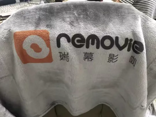Removie multi-color logo sublimation printed on light gray blanket
